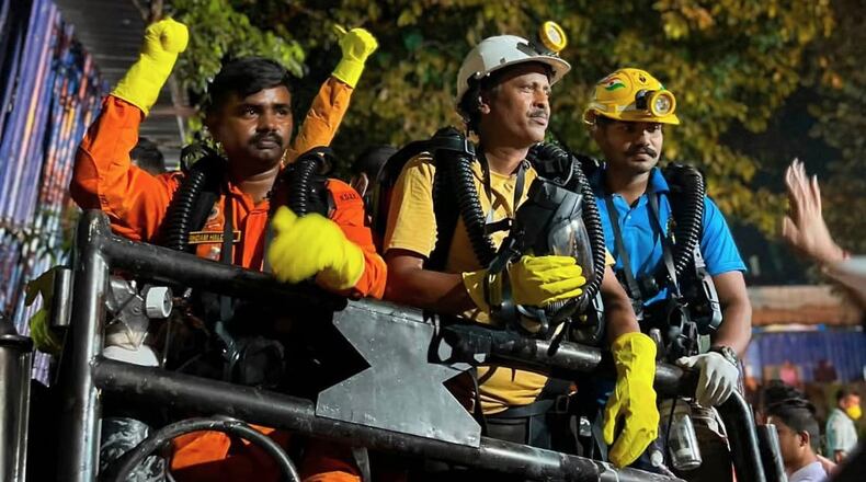 In this image provided by the Information and Public Relations Department, Government of Sikkim, rescue workers stand outside an under-construction tunnel at a hydropower project in Samardung village, about 40 kilometers (25 miles) from Gangtok, India, Wednesday, July 22, 2026. (Government of Sikkim via AP)