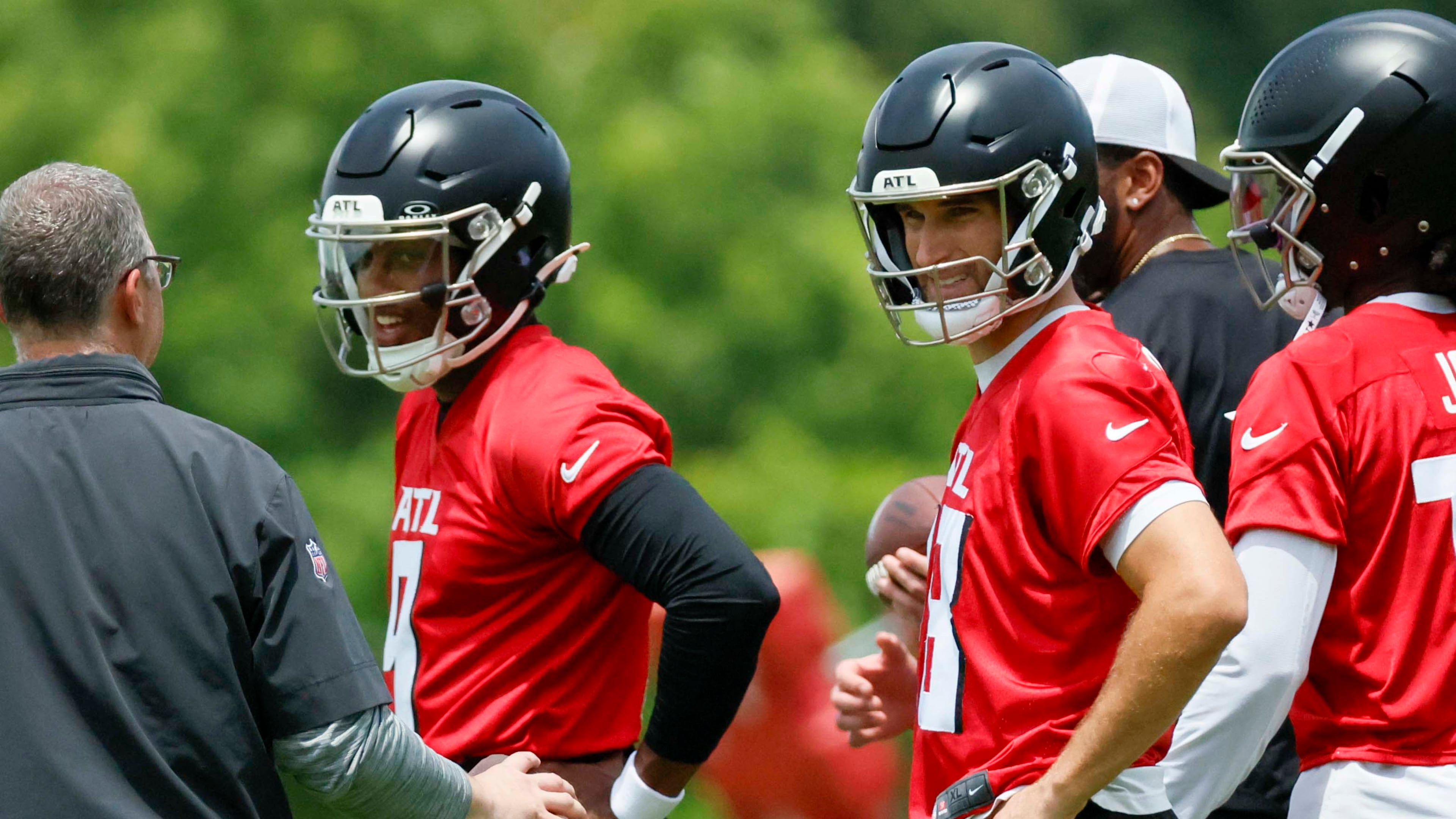 Atlanta Falcons quarterbacks Kirk Cousins (right) and Michael Penix Jr. listen to instructions during minicamp at the Atlanta Falcons Training Facility on Wednesday, June 11, 2025, in Flowery Branch, Ga. (Miguel Martinez/AJC)