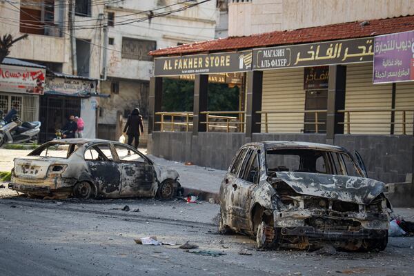 Burnt cars remain in the middle of a street following the recent wave of violence between Syrian security forces and gunmen loyal to former President Bashar Assad, as well as subsequent sectarian attacks, in the town of Jableh, Syria's coastal region, Monday, March 10, 2025. (AP Photo/Omar Albam)