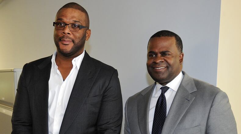 Atlanta Mayor Kasim Reed, and filmmaker Tyler Perry at the event announcing Perry's purchase of 330 acres at the former Fort McPherson Army base on Aug. 8, 2014, in Atlanta. AJC file photo: David Tulis