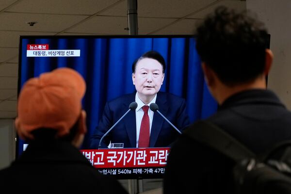 FILE - People watch a TV screen showing South Korean President Yoon Suk Yeol's televised briefing at a bus terminal in Seoul, South Korea, Dec. 3, 2024. (AP Photo/Ahn Young-joon, File)