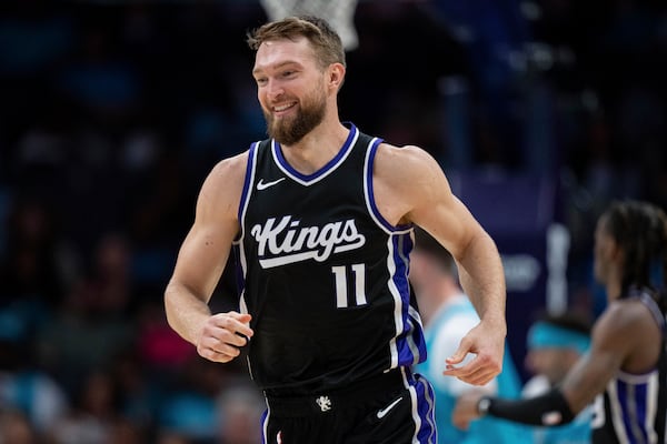 Sacramento Kings forward Domantas Sabonis (11) reacts during the first half of an NBA basketball game against the Charlotte Hornets, Friday, April 4, 2025, in Charlotte, N.C. (AP Photo/Jacob Kupferman)