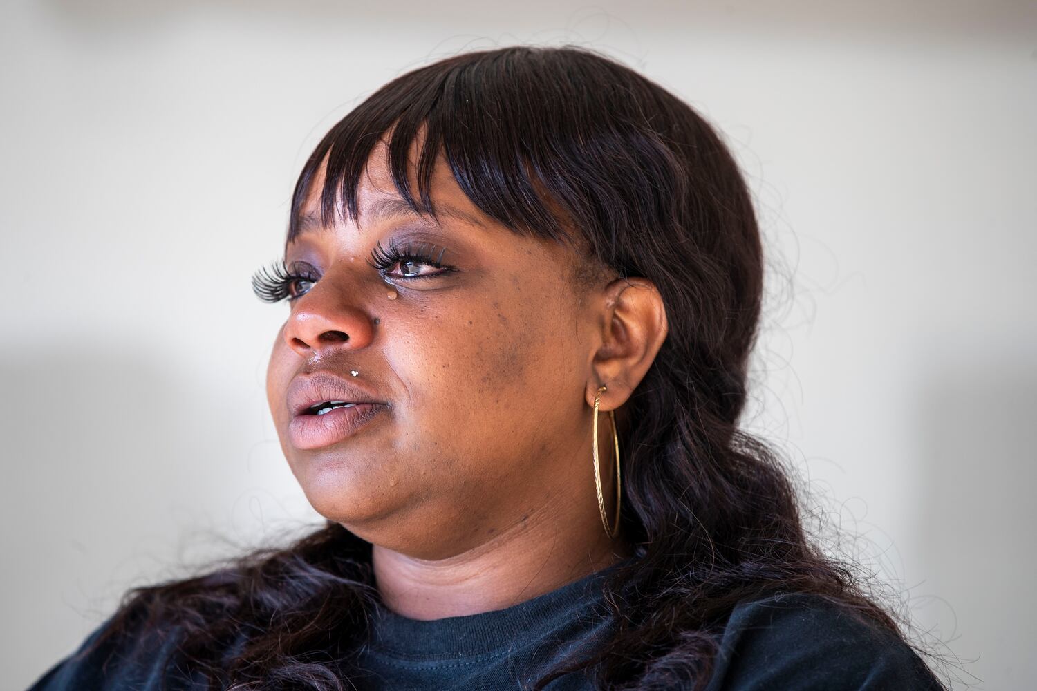 Brittany Mitchell becomes emotional as she recounts her experience riding out the tornado at her residence in Newnan. (Alyssa Pointer / Alyssa.Pointer@ajc.com)