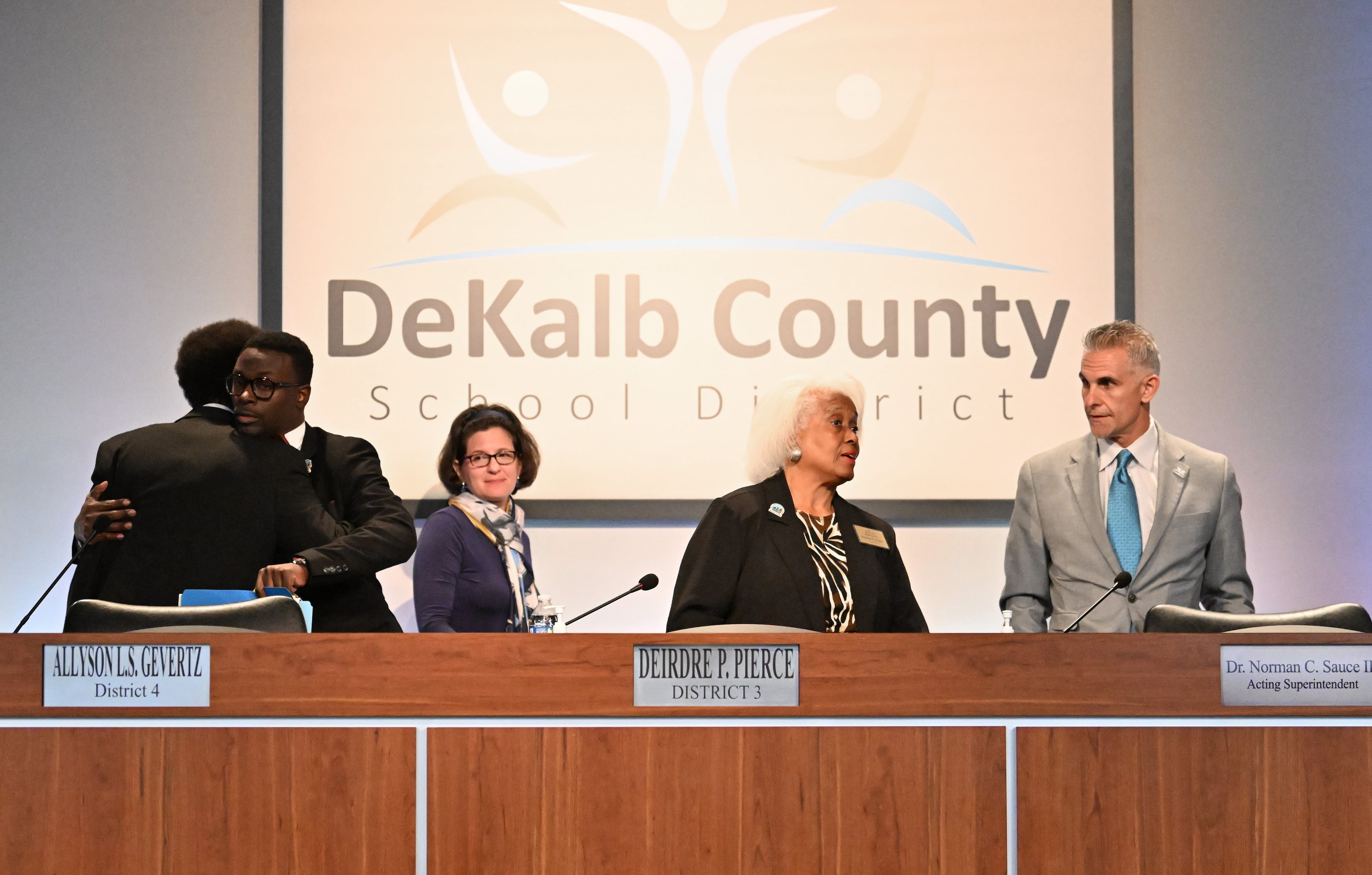 DeKalb school board chair Deirdre Pierce talks to acting superintendent Norman Sauce III, right, after school board members voted to accept the resignation of Devon Horton at DeKalb County School District headquarters, Wednesday, October 15, 2025, in Stone Mountain. (Hyosub Shin/AJC)