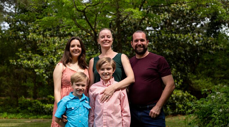 Anna Hoppmann-Lemoine and her stepdaughter Camille, husband Val, and two kids Noah and Gabriel pose for a family photo outside of their house in Marietta, Georgia, on April 30, 2021. Camille, Anna, (Rebecca Wright for the Atlanta Journal-Constitution)