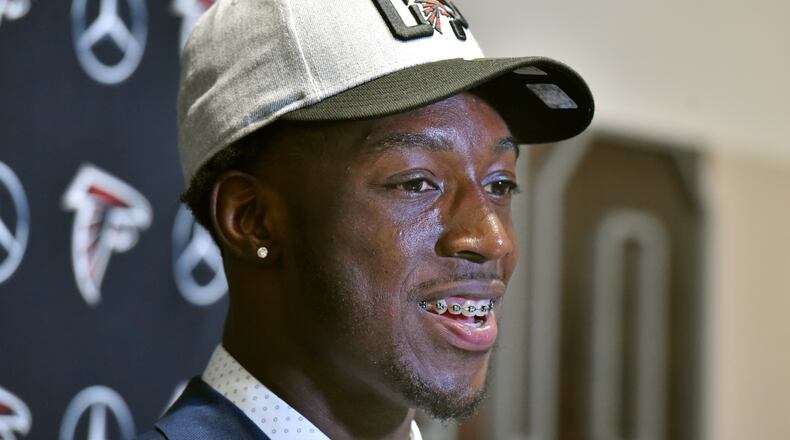 Falcons first-round pick Calvin Ridley is all smiles and orthodontics during his introductory press conference at the Falcons training facility Friday. (HYOSUB SHIN / HSHIN@AJC.COM)
