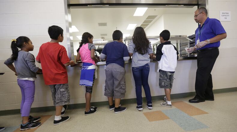 Immigrant children line up in the cafeteria at the Karnes County Residential Center, a detention center for immigrant families, in Karnes City, Texas. Sept. 10, 2014. AP Photo/Eric Gay