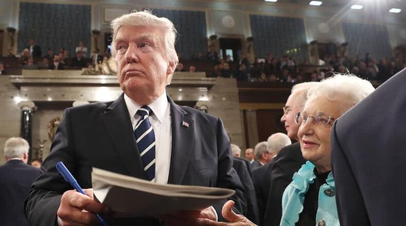 President Donald J. Trump signs an autograph on his way out after delivering his first address to a joint session of Congress from the floor of the House of Representatives in Washington, DC, USA, 28 February 2017.
