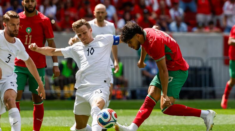 Norway midfielder Martin Odegaard (10) fights for the ball against Morocco forward Abde Ezzalzouli during an international friendly soccer match, Sunday, June 7, 2026, in Harrison, N.J. (AP Photo/Eduardo Munoz Alvarez)