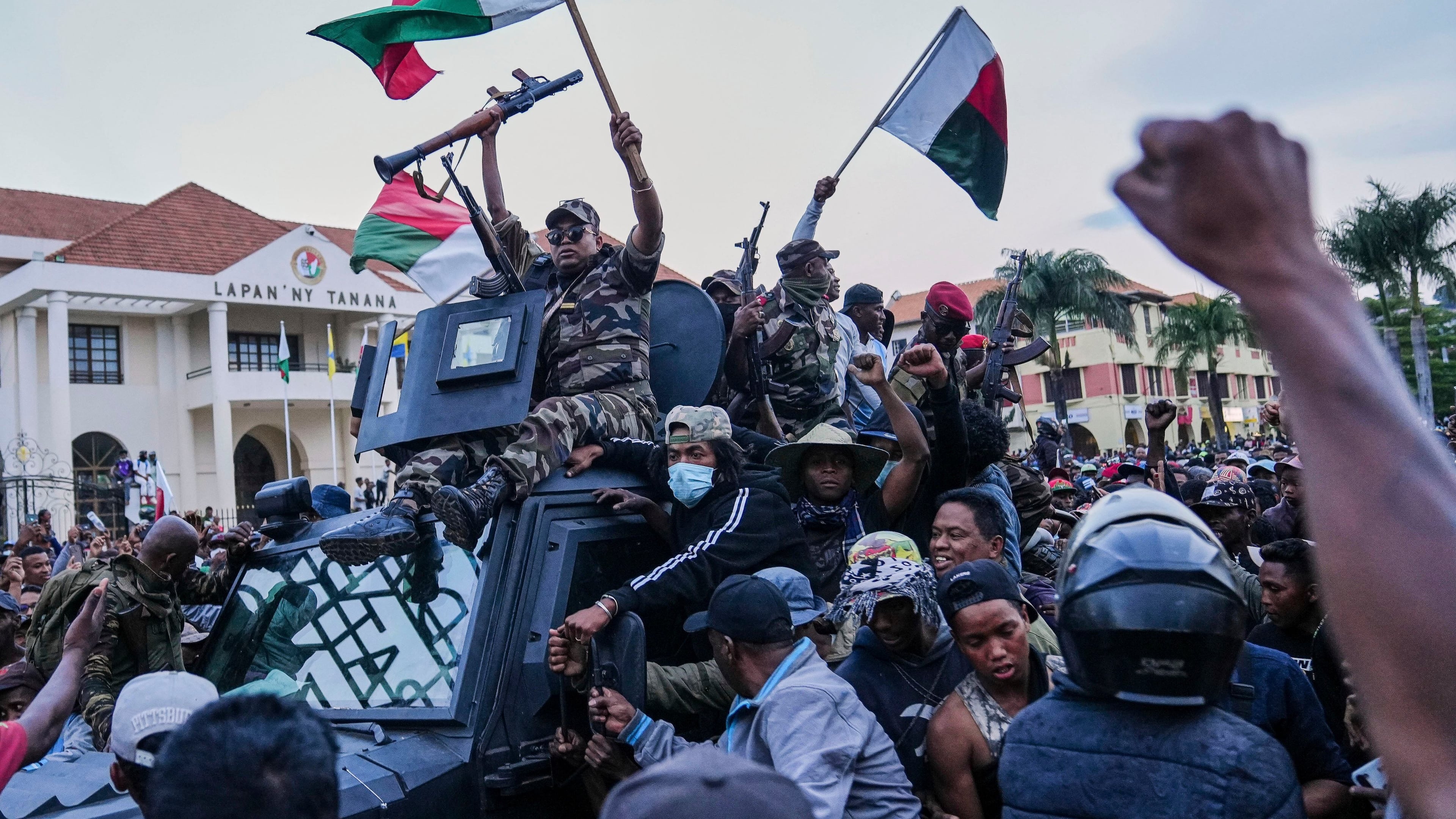 Soldiers are greeted by people gathering for a ceremony in tribute to demonstrators killed during recent anti-government protest in Antananarivo, Madagascar, Sunday, Oct. 12, 2025. (AP Photo/Mamyrael)