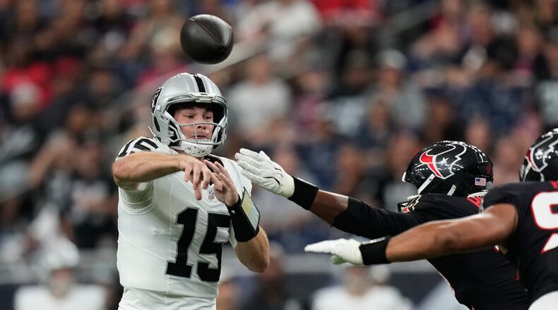 Las Vegas Raiders quarterback Fernando Mendoza (15) throws against the Houston Texans while under pressure during the first half of an NFL preseason football game, Thursday, Aug. 20, 2026, in Houston. (AP Photo/Ashley Landis)