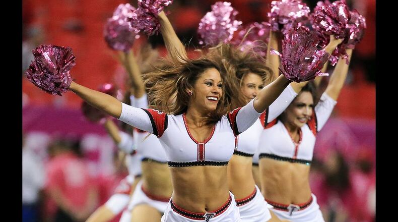 The Falcons cheerleaders sport pink pom poms for breast cancer awareness as they preform during the game against the Texans on Sunday, Oct. 4, 2015, in Atlanta. Curtis Compton