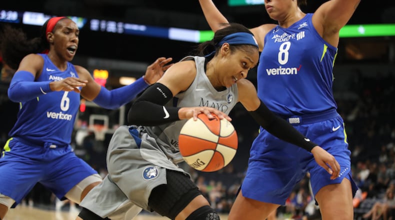 The Minnesota Lynx's Maya Moore dribbles past the Dallas Wings' Kayla Thornton, left, and Liz Cambage at Target Center in Minneapolis on Tuesday, June 19, 2018. The Lynx won, 91-83. (Jerry Holt/Minneapolis Star Tribune/TNS)