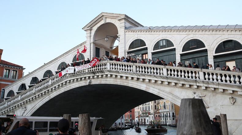 Workers and orchestra members of Venice’s La Fenice theater, joined by other performing arts professionals, march through the city demanding the resignation of superintendent Nicola Colabianchi and artistic director Beatrice Venezi, in Venice, Italy, Monday, Nov. 10, 2025. (Paola Garbuio/LaPresse via AP)