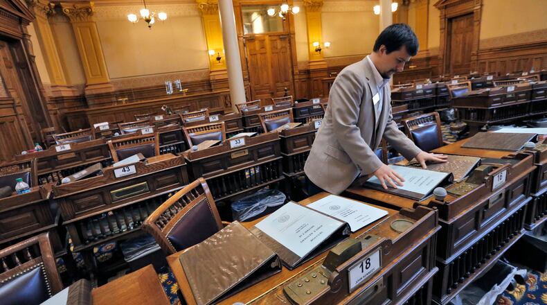April 1, 2015 - Atlanta - Senate staffer Joseph Castleberry preps senate binders for the last day of the session. House and senate staffers were busy preparing for Sine Die, day 40 of this years legislative session, which is April 2. BOB ANDRES / BANDRES@AJC.COM Staffer Joseph Castleberry preps Senate binders for the last day of the session. Bob Andres, bandres@ajc.com