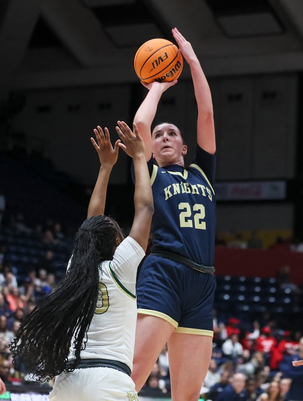 River Ridge forward Finley Parker (22) attempts a shot against Langston Hughes Kylar-Rae Johnson (20) during the first half in the GHSA Girls 5A State Championship at the Macon Centreplex, Friday, March, 7, 2025, in Macon, Ga. (Jason Getz / AJC)