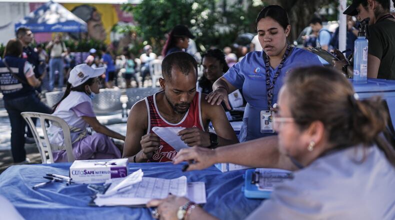 Health workers treat people affected by the earthquake three days after it hit Cali, Colombia, Thursday, Aug. 13, 2026. (AP Photo/Ivan Valencia)
