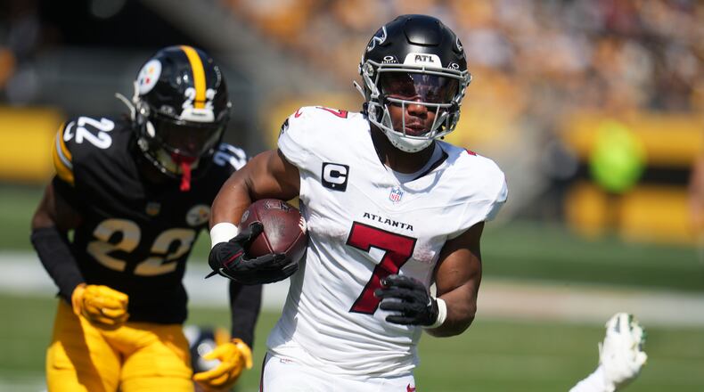 Atlanta Falcons running back Bijan Robinson (7) runs in for a touchdown during an NFL football game against the Pittsburgh Steelers, Sunday, Sept. 13, 2026, in Pittsburgh. (AP Photo/Gene J. Puskar)
