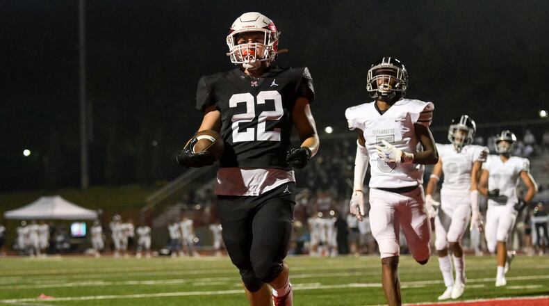 Milton running back Scott Moskowitz (22) reaches the end zone for a touchdown in the second half of Friday's 55-27 victory over Alpharetta. (Daniel Varnado/Special to the AJC