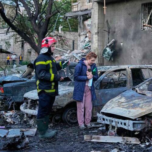 An owner looks at her damaged car following a Russia missile attack in Kyiv, Ukraine, Sunday, July 19, 2026. (AP Photo/Efrem Lukatsky)