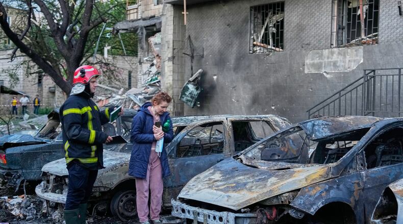 An owner looks at her damaged car following a Russia missile attack in Kyiv, Ukraine, Sunday, July 19, 2026. (AP Photo/Efrem Lukatsky)