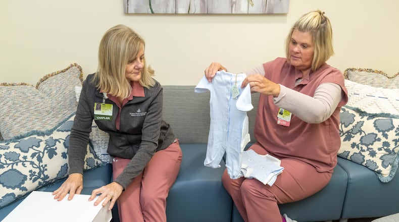 Northeast Georgia Medical Center Bereavement team members Chaplain Reverend Karen Hoyt M.Div, BCC (left) & Mandy Reichert, PhD, RN, PT-CSP look through their assortment of baby clothes that they can offer for burials. A nurse who has the sad duty of dressing for burial babies that don't make it contacted a manufacturer of really smart children's clothes. He has given them some and they are needed because some parents don't have or can't afford a proper burial outfit for their babies. For Inspire Atlanta about nurses going above and beyond. PHIL SKINNER FOR THE ATLANTA JOURNAL-CONSTITUTION