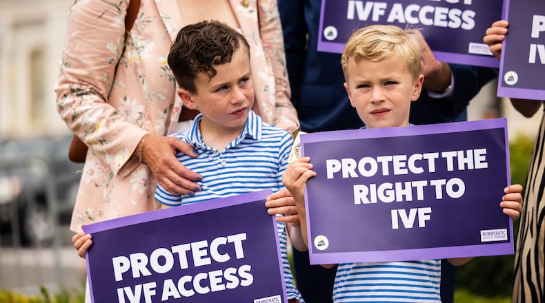 Liam Mullin, left, and Landon Mullin, the sons of Rep. Kevin Mullin (D-CA), hold signs during a news conference in honor of World IVF Day to discuss the next steps for legislation to protect access to in vitro fertilization across America, on July 25, 2024, in Washington, D.C. (Tierney L. Cross/Getty Images/TNS)