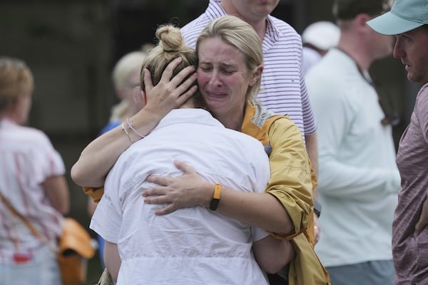 Families are reunited at a reunification center after flash flooding it the area, Friday, July 4, 2025, in Ingram, Texas. (AP Photo/Eric Gay)