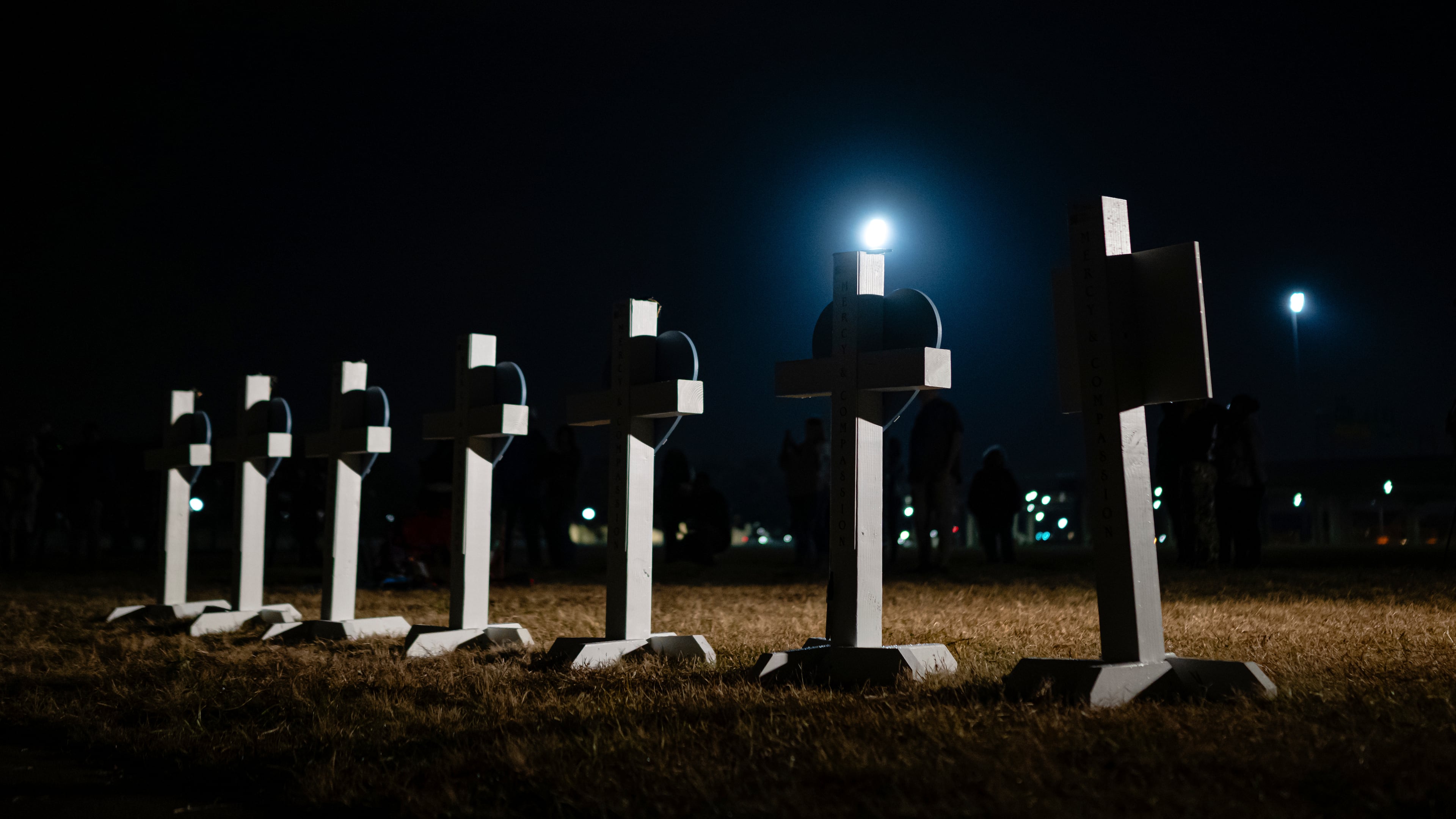 Crosses stand during a vigil for those killed and missing after a UPS plane crashed, at the Great Lawn, Friday, Nov. 7, 2025, in Louisville, Ky. (AP Photo/Jon Cherry)
