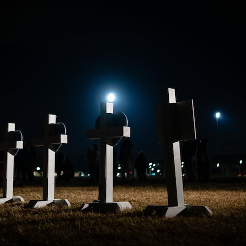Crosses stand during a vigil for those killed and missing after a UPS plane crashed, at the Great Lawn, Friday, Nov. 7, 2025, in Louisville, Ky. (AP Photo/Jon Cherry)