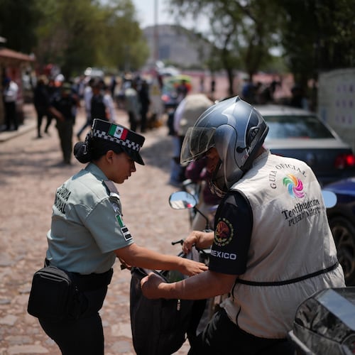 Police search visitors at the Teotihuacan pyramids as the archaeological site reopened two days after a gunman opened fire killing a Canadian tourists, outside Mexico City, Wednesday, April 22, 2026. (AP Photo/Eduardo Verdugo)