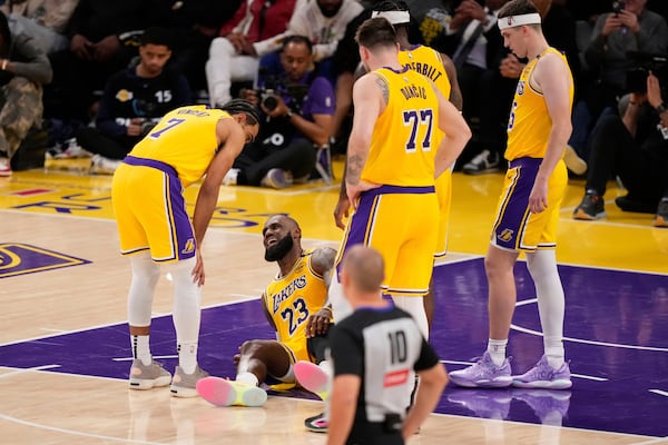 Los Angeles Lakers forward LeBron James lays on the floor after injuring his knee during the second half in Game 5 of an NBA basketball first-round playoff series against the Minnesota Timberwolves, Wednesday, April 30, 2025, in Los Angeles. (AP Photo/Mark J. Terrill)