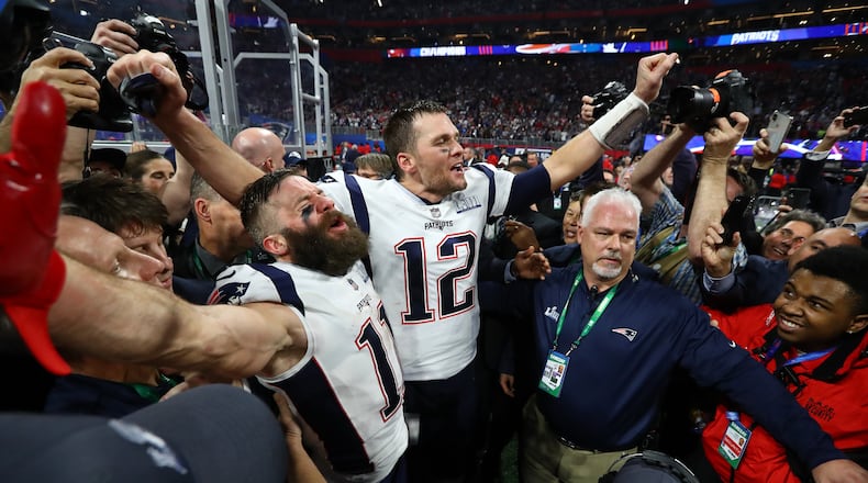 2/3/19 - Atlanta - New England Patriots wide receiver Julian Edelman (11) and New England Patriots quarterback Tom Brady (12) celebrate their 13-3 win against the Los Angeles Rams in Super Bowl LIII on Sunday, Feb. 3, 2019 at Mercedes-Benz Stadium in Atlanta, Ga. 
CURTIS COMPTON / CCOMPTON@AJC.COM