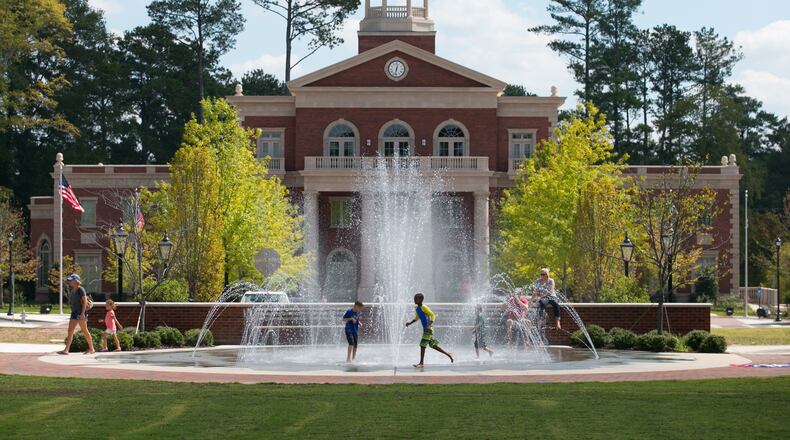 Children play in front of a fountain at Alpharetta City Hall.