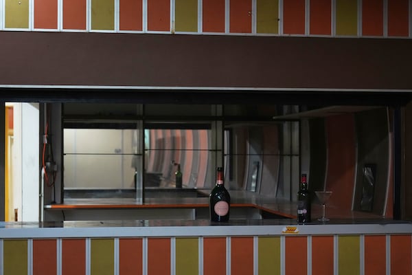 Bottles and glasses left on the counter of one of the bars that operated from the 1980's, are seen during a press tour in London, Thursday, June 19, 2025. (AP Photo/Joanna Chan)