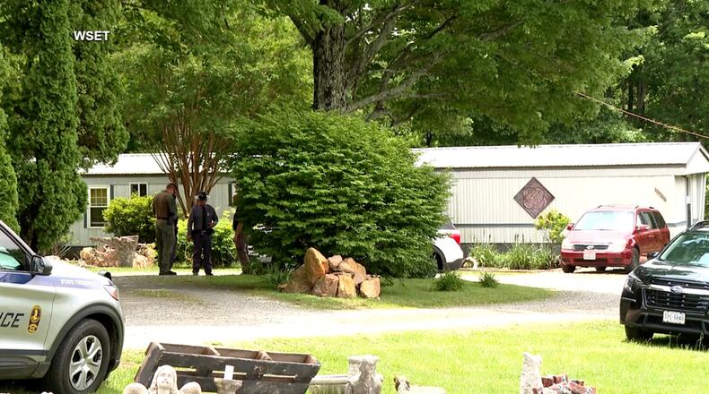 This image taken from video shows law enforcement at the scene of Michael Puckett's home in Carroll County, Va., on Saturday, May 30, 2026. (WSET via AP)