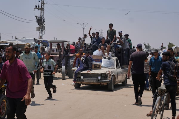 Palestinians carry food and humanitarian aid packages delivered by the Gaza Humanitarian Foundation, a U.S.-backed organization, in Rafah, southern Gaza Strip, Tuesday, June 10, 2025. (AP Photo/Abdel Kareem Hana)
