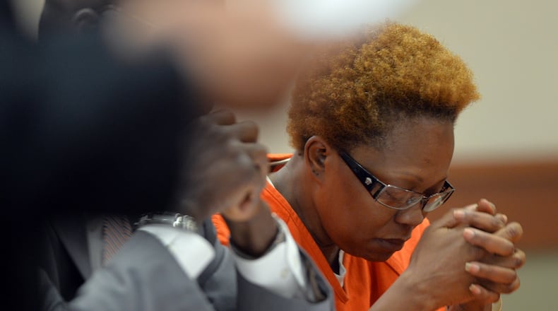Pamela Ballin listens as Deputy Chief ADA Eric Dunaway reads a victim impact statement from Ricky Ballin's daughter. DeKalb Superior Court Judge Mark Anthony Scott presides over a hearing Thursday, July 17, 2014 to decide whether to set aside the murder jury verdict of guilty of Pamela Ballin. Ballin was convicted last month of killing her husband, Derrick "Ricky" Ballin Sr. in 2009. Judge Scott sentenced her to a life term for the murder after denying motions for mistrial and directed verdict. The judge allowed Ballin to stay free after the jury declared her guilty last month of murdering her husband but then ordered her jailed after the public outcry. KDJOHNSON/KDJOHNSON@AJC.COM