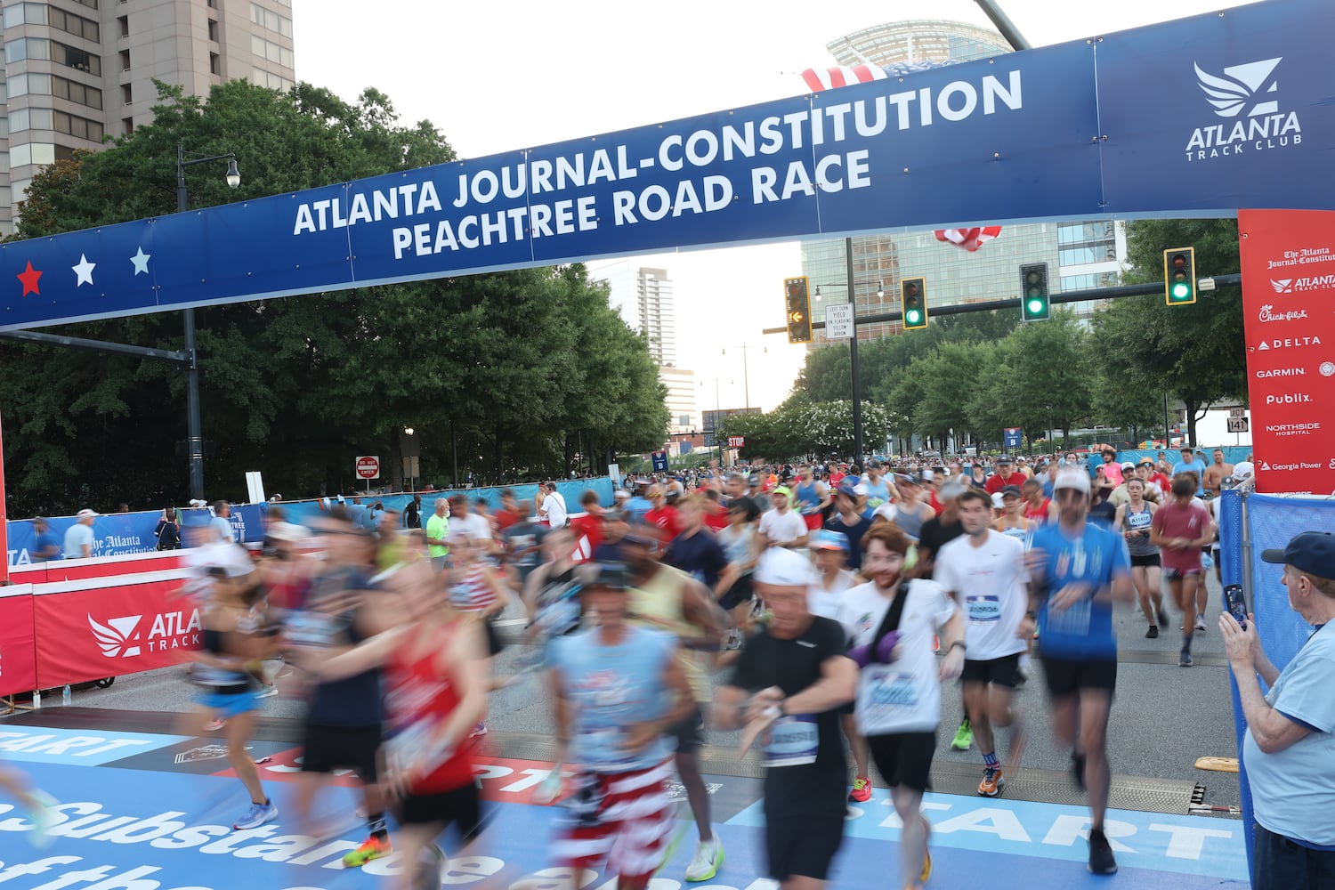The first wave of runners take off at the start of the 56th running of the Atlanta Journal-Constitution Peachtree Road Race on Friday, July 4, 2025, in Atlanta. (Arvin Temkar/AJC)