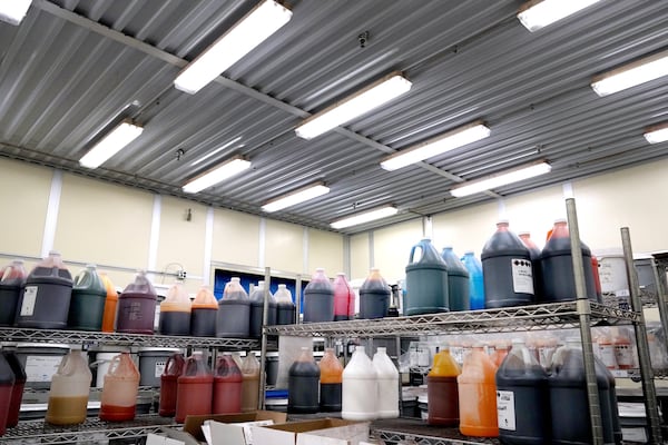 Liquid color samples are stored in bottles in a room at Sensient Technologies Corp., a color additive manufacturing company, in St. Louis, on Wednesday, April 2, 2025. (AP Photo/Jeff Roberson)