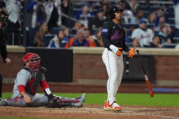 St. Louis Cardinals catcher Pedro Pagés, left, watches as New York Mets' Francisco Lindor hits a walk-off home run during the ninth inning of a baseball game Friday, April 18, 2025, in New York. (AP Photo/Frank Franklin II)