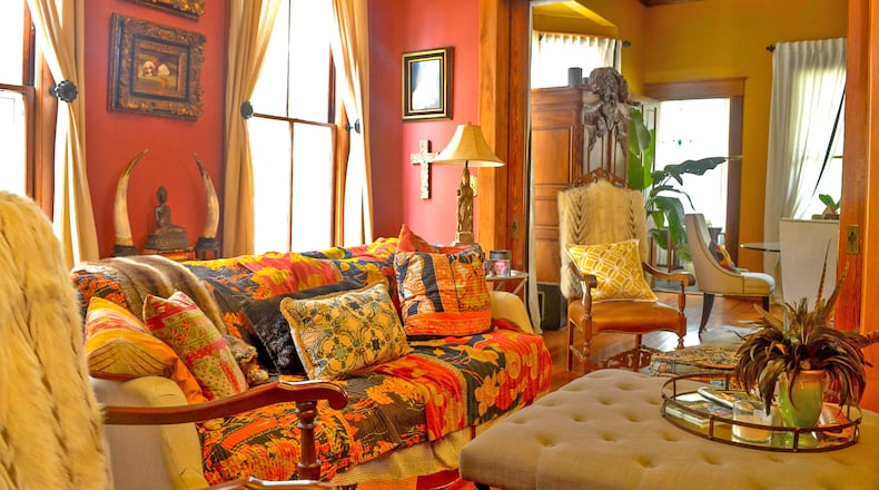 English said she painted her family room red because it represents happiness and good luck. The lively wall color is echoed in the Indian blankets that cover her custom sofa.