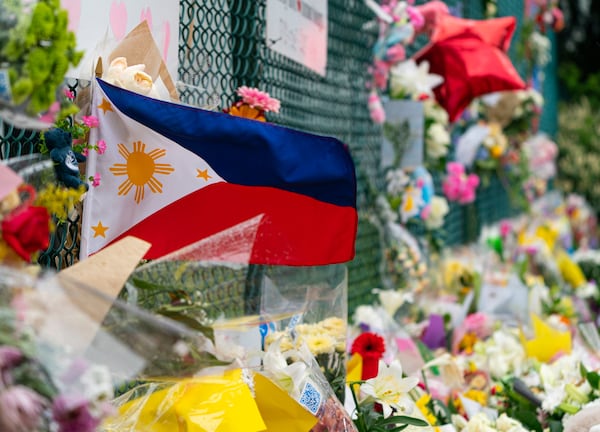 A Philippines flag waves in the wind at a memorial site for the victims of an incident where a car drove through a crowd killing multiple people in Vancouver, British Columbia, Monday, April 28, 2025. (Rich Lam/The Canadian Press via AP)