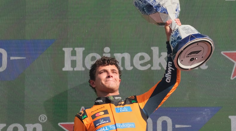 McLaren driver Lando Norris of Britain holds the trophy after winning the Formula One Dutch Grand Prix in Zandvoort , Netherlands, Sunday, Aug. 23, 2026. (AP Photo/Patrick Post)