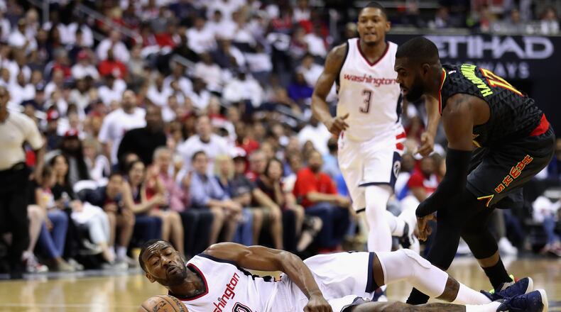 WASHINGTON, DC - APRIL 16: John Wall #2 of the Washington Wizards and Tim Hardaway Jr. #10 of the Atlanta Hawks go after a loose ball in the first half of Game One of the Eastern Conference Quarterfinals during the 2017 NBA Playoffs at Verizon Center on April 16, 2017 in Washington, DC. NOTE TO USER: User expressly acknowledges and agrees that, by downloading and or using this photograph, User is consenting to the terms and conditions of the Getty Images License Agreement. (Photo by Rob Carr/Getty Images)