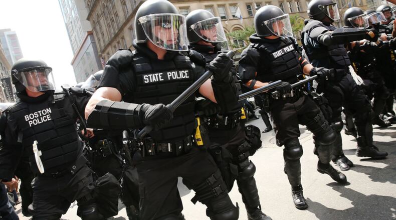 BOSTON, MA - AUGUST 19: Protesters face off with riot police escorting conservative activists following a march in Boston against a planned 'Free Speech Rally' on August 19, just a week after the violent 'Unite the Right' rally in Virginia left one woman dead and dozens more injured. Although the rally organizers stress that they are not associated with any alt-right or white supremacist groups, the city of Boston and Police Commissioner William Evans are preparing for possible confrontations at the afternoon rally. (Photo by Spencer Platt/Getty Images)