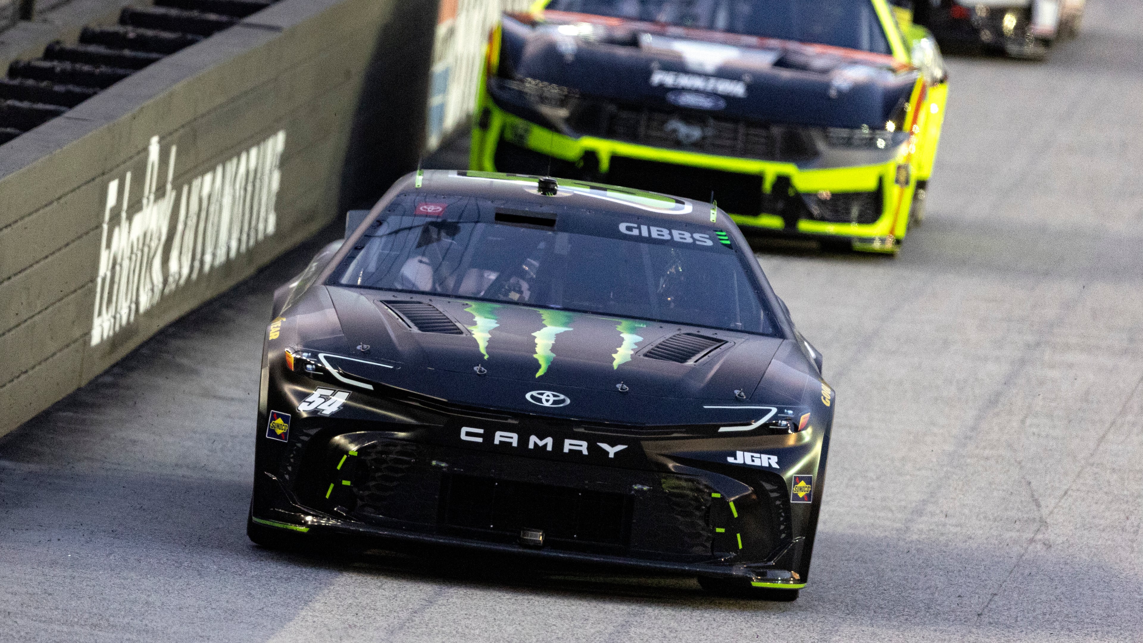Ty Gibbs (54) leads Ryan Blaney (12) during a NASCAR Cup Series auto race, Saturday, Sept. 13, 2025, in Bristol, Tenn. (AP Photo/Wade Payne)