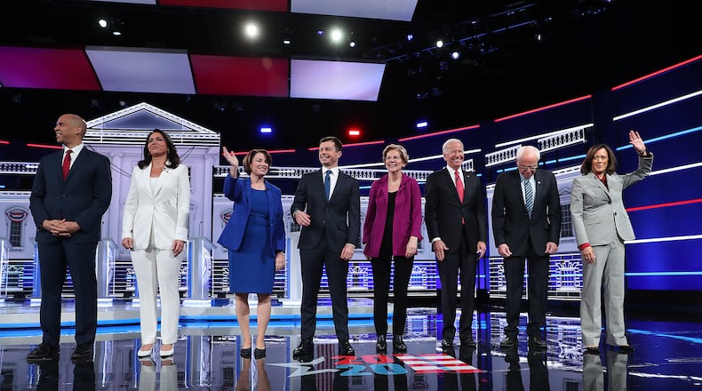 Democratic presidential candidates (L-R) Sen. Cory Booker (D-NJ), Rep. Tulsi Gabbard (D-HI), Sen. Amy Klobuchar (D-MN), South Bend, Indiana, Mayor Pete Buttigieg, Sen. Elizabeth Warren (D-MA), former Vice President Joe Biden, Sen. Bernie Sanders (I-VT), and Sen. Kamala Harris (D-CA), arrive on stage before the start of the Democratic presidential debate at Tyler Perry Studios in Atlanta. Ten Democratic presidential hopefuls qualified from the larger field of candidates to participate in the debate hosted by MSNBC and The Washington Post.