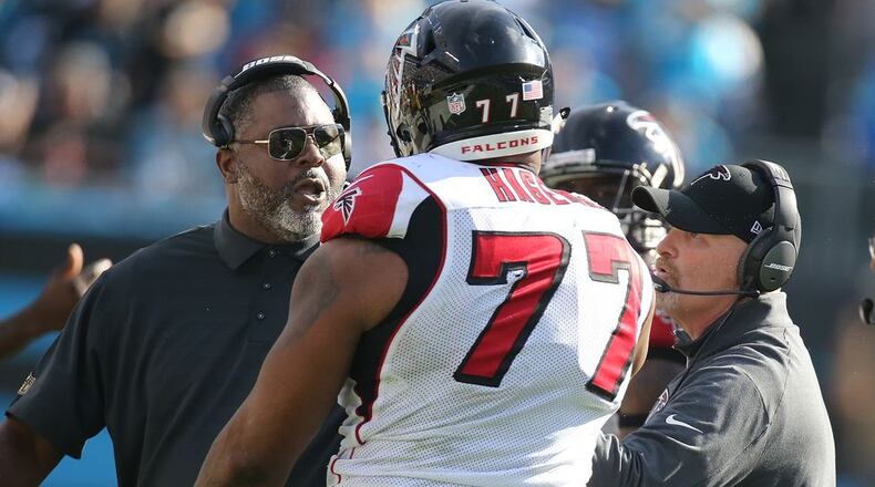 Brian Cox instructs Ra'Shede Hageman in the finer points of shoving. (Curtis Compton/AJC)