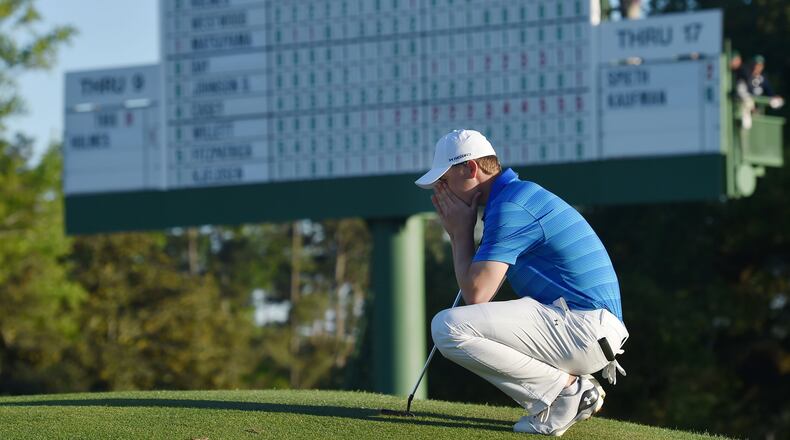 Jordan Spieth gathers his thoughts on the 18th green in front of the leaderboard before finishing his final round of the 80th Masters at the Augusta National Golf Club, Sunday, April 10, 2016. Brant Sanderlin/ AJC file